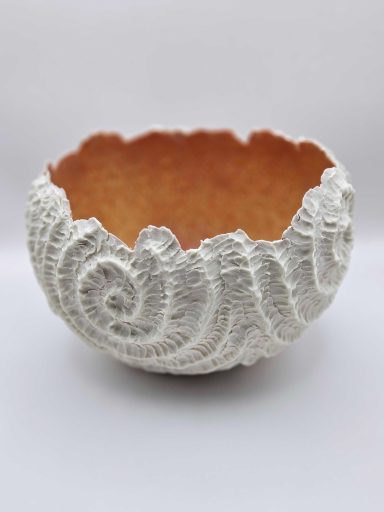 Orange and white porcelain bowl with spiral pattern