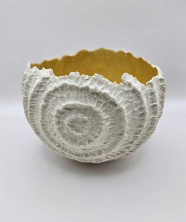 Textured white porcelain bowl with yellow-glazed interior